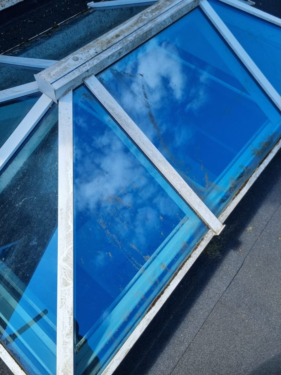 A lantern roof before cleaning, with dirt on the glass and frames