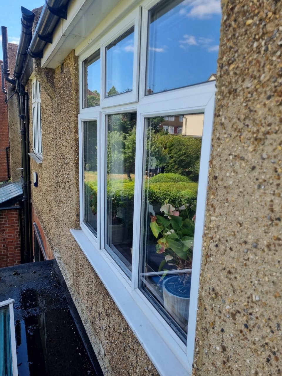 The same windows after cleaning, with clear glass and a clean sill