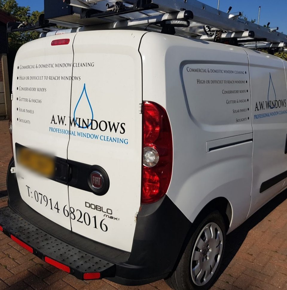 The back of the A.W. Windows van, lettered with commercial and domestic window cleaning and its services