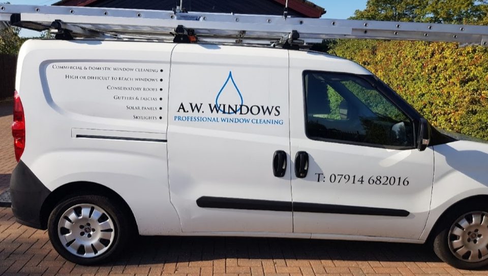 The white A.W. Windows van with its blue water drop logo